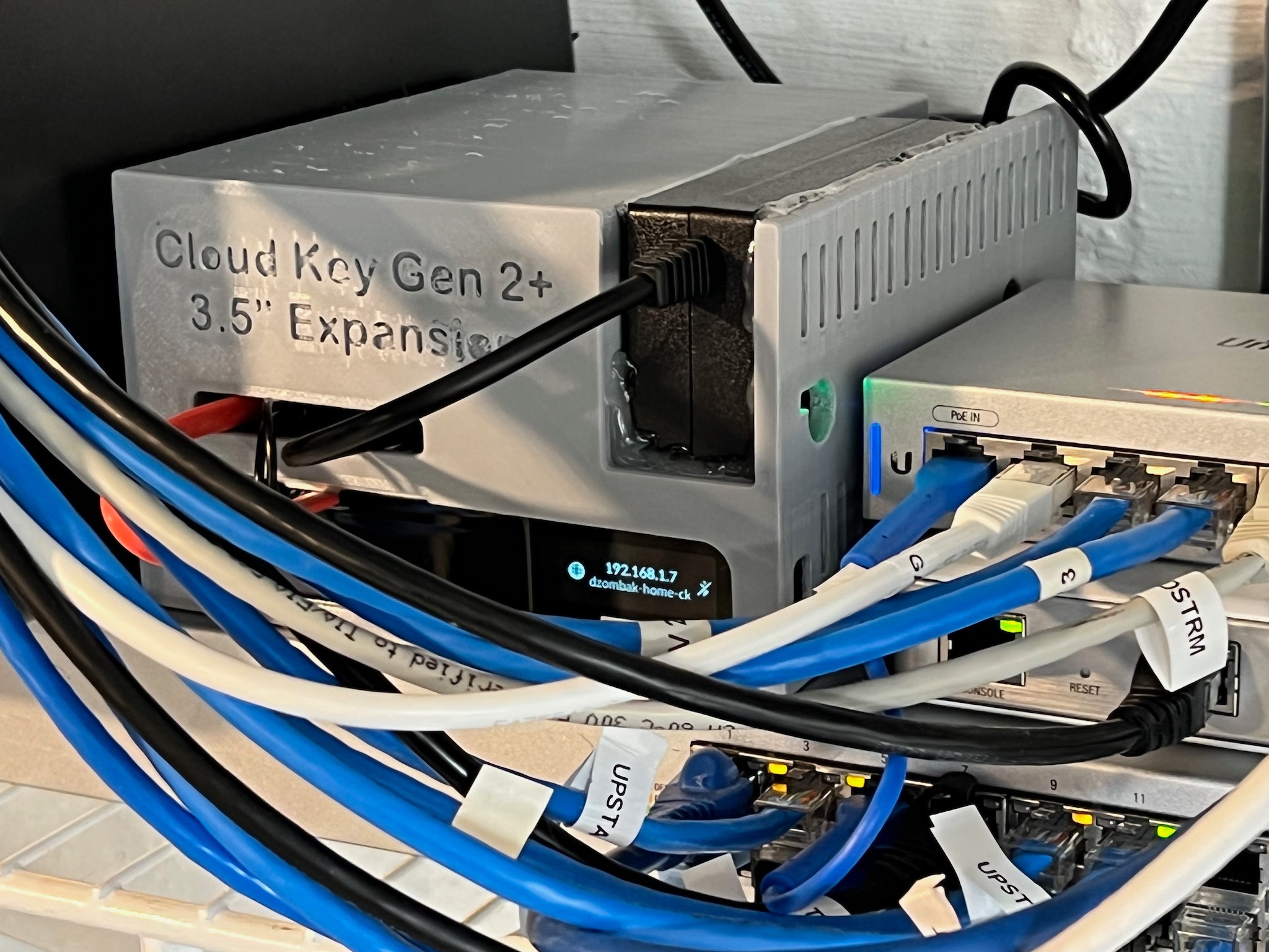 Cloud Key Expansion project in its enclosure alongside other networking gear