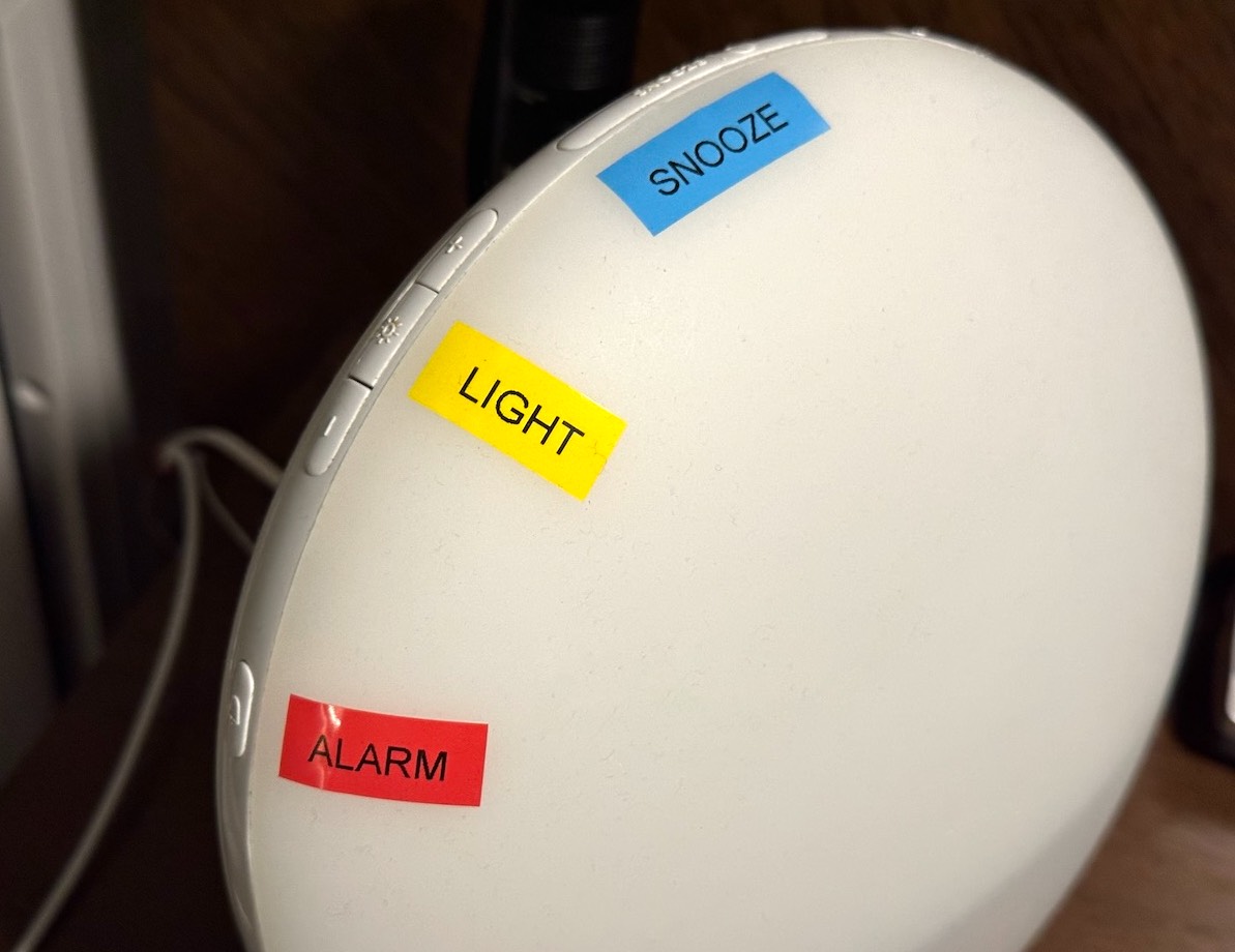 Sunrise alarm clock with colored labels for the Alarm, Light, and Snooze buttons