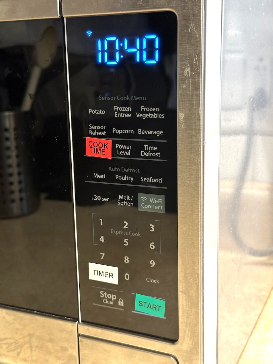 Microwave control panel with colored labels for the Cook Time, Timer, and Start buttons